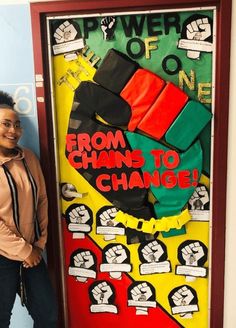 a woman standing in front of a door decorated with black lives matter signs and posters