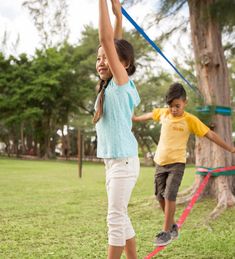 two young children playing with a toy in a park