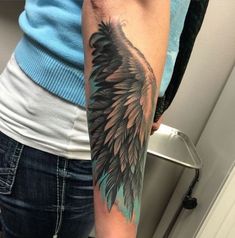 a person with a black and grey tattoo on their arm