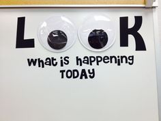 a sign that says look what is happening today on the side of a door with buttons