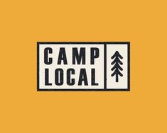 a sign that says camp local on the side of a yellow wall with pine trees