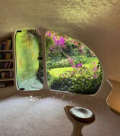 a room with two windows that look out to a garden and flowers on the outside