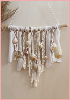 a wall hanging with seashells on it