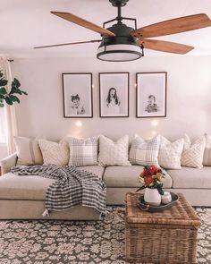 a living room filled with furniture and pictures hanging on the wall behind a ceiling fan