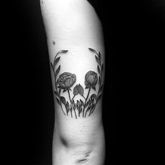 a black and white photo of flowers on the arm