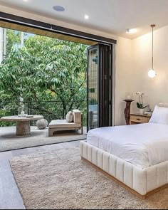 a bedroom with a large bed and sliding glass doors leading to an outside patio area