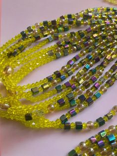 Double Strand Waist Bead, featuring vibrant yellow crystal glass beads with striking square purple AB crystal accents. Why You'll Love It: Vibrant Sparkle: Gorgeous yellow crystal glass beads radiate a lively, eye-catching brilliance. Unique Accents: Square purple AB crystal beads add a distinctive and luxurious touch. Perfect Fit: The adjustable double strand design ensures a comfortable and secure fit for all body types. Cultural Elegance: This piece captures the rich heritage of Ivorian craftsmanship, blending traditional beauty with contemporary style. Color Significance: Yellow: In Ivorian culture, yellow symbolizes happiness, energy, and vitality. Wearing yellow beads can uplift your spirit and evoke a sense of joy and warmth. Purple: Purple represents royalty, wisdom, and spirituali Yellow Rectangular Beaded Jewelry, Adjustable Yellow Beaded Bracelet For Parties, Yellow Bohemian Rectangular Jewelry, Yellow Rectangular Bohemian Jewelry, Yellow Beaded Necklaces With Faceted Beads For Gift, Yellow Faceted Beads Necklace As Gift, Yellow Faceted Beads Necklace For Gift, Yellow Glass Beaded Chain Jewelry, Yellow Spacer Beads For Gifts