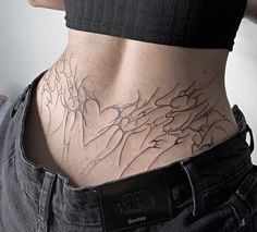 the back of a person's stomach with tattoos on it