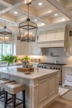 a large kitchen with white cabinets and an island