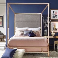 a bedroom with blue walls and a canopy bed