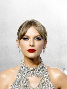 a woman with red lipstick and silver jewelry