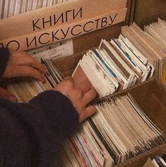 a person picking up records from a box