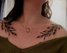 a woman's chest with leaves and moon tattoos on it