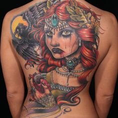 the back of a woman's tattoo with a bird on her shoulder and head