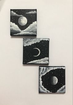 three small black and white paintings with the moon in the sky above them on a wall