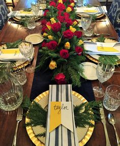 the table is set with flowers and place settings