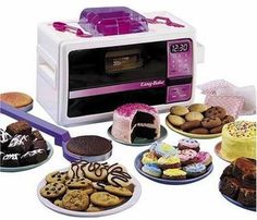 a microwave oven with many different types of cakes and cookies in front of it on plates