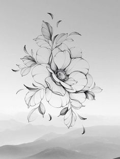 a black and white photo of flowers in the air with mountains in the distance behind it