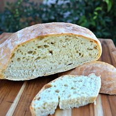 a loaf of bread sitting on top of a wooden cutting board