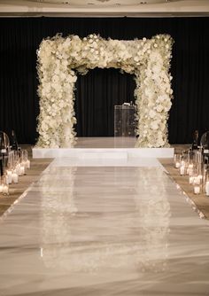 a white wedding aisle with candles and flowers