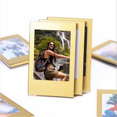 three gold colored frames with photos on them