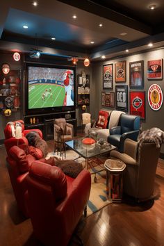 A lively sports-themed lounge featuring a large projector screen, assorted memorabilia, and neon signs. Modern Sports Room, Sports Family Room, Game Room With Fireplace, Sports Den Decorating Ideas, Sports Game Room Ideas, Lounge Game Room Ideas, Vintage Sports Basement, Man Cave Sports Room, Game Lounge Room