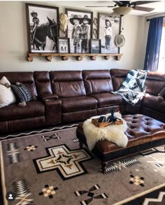 a living room with brown leather furniture and pictures on the wall above it's couch