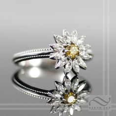 A simple and fun daisy with, this ring features natural diamonds or moissanite, as the white petals with the center stone being a yellow diamond in either case. All rings are carefully crafted using USA refined solid white gold and quality stones that will dazzle in the sun. Features: ~Solid 14k white gold ~Diamonds will be fair trade, SI-1, GH or better, Marquise cuts, 3x1.5mm each ~If moissanite is selected, I use stones of a matching grade and clarity. ~All stones are beautifully cut, eye cle White Flower Ring With Center Stone, White Diamond Ring With Rose Cut Flower Shape, White Diamond Flower Ring With Rose Cut, White Flower-shaped Diamond Ring With Halo Setting, White Flower-shaped Diamond Ring, White Diamond Flower Ring With Halo Setting, White Rose Cut Diamond Flower Ring For Anniversary, White Petals, Daisy Ring