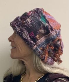 "This hat is part hand-felt and part hand-knit and then hand-stitched. There are lots of intricate details in the felt. I don't discard any of my fibers in the shop. Nothing! I use bits of yarns, cuttings, threads - all of it. No waste! :) This felt is over a solid fabric and it is nuno felted which means the look is crinkled = just more texture is what this means. I love texture and subtle colors. This hat is full of color. Muted with some bursts of brightness but not overbearing. The hat measures 26\" inside and will stretch with the knit but it also fits smaller heads (as pictured a small head) as the bottom can be rolled or turned up.    The knit is a bouquet of colors as well. An acrylic. Could have a few surprises in the there too. :0 The floppy bits are knit into the hat. Stripped r Felted Hat, Sari Ribbon, No Waste, Hand Felted, Slouchy Hat, Nuno Felting, Felt Hat, Color Free, Free Knitting