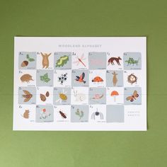 the woodland alphabet poster is displayed on a green background with other animals and plants around it