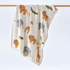 a blanket with animals on it hanging from a clothes line