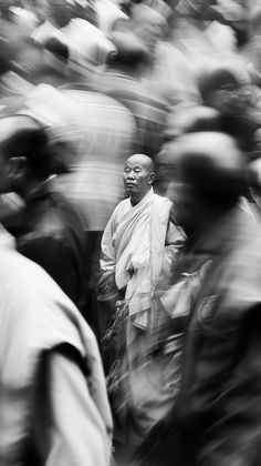 a black and white photo of a man standing in front of a group of people