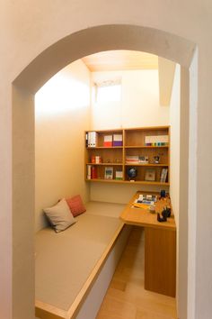 a room with a bed, desk and bookshelf in the middle of it