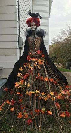 a costume made out of branches and leaves with a skeleton in the middle on top