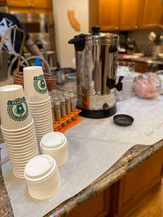 stacks of coffee cups sitting on top of a counter