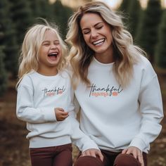 Thankful Mini Crewneck Sweatshirt to go with Thankful Mama sweatshirt, Mommy and Me Matching for Thanksgiving Season, Autumn Season. Perfect for cozy family gatherings and matching outfits during the fall season. Ideal for moms and their children who want to create lasting memories together. For Mama Shirt please go to other listing: https://thewildlivingco.etsy.com/listing/1814631165/thankful-mama-crewneck-sweatshirt-mommy Product features - 50% Cotton 50% Polyester blend for durability and smooth fabric - Knitted in one piece without side seams to reduce fabric waste - Ribbed knit collar with seam for elasticity and shape retention - Medium-heavy fabric for warmth (8.0 oz/yd²) - Loose fit for comfortable wear Care instructions - Machine wash: cold (max 30C or 90F) - Non-chlorine: bleach Matching Thanksgiving Shirts, Thanksgiving Style, Thankful Mama, Mama Crewneck, Thanksgiving Fashion, Mama Shirts, Mama Sweatshirt, Thanksgiving Shirts, Autumn Season