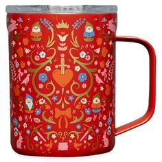 a red mug with an ornate design on it