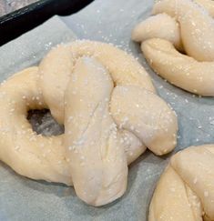 three doughnuts sitting on top of wax paper