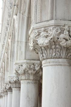 the columns are all white and have carvings on them in order to make it stand out from the rest of the building