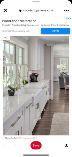 an iphone photo of a kitchen with white cabinets