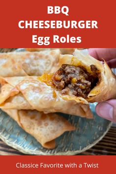 a hand holding up a burrito with cheeseburger egg rolls in it on a plate