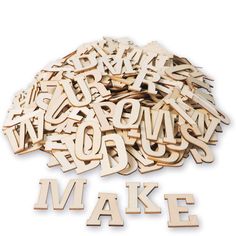 wooden letters spelling out the word make on a white background with clippings to spell out words