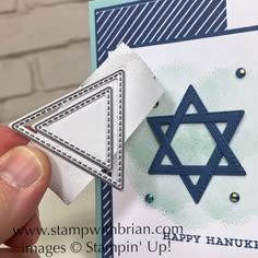 someone holding up a card with a star of david on it