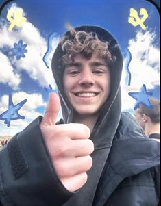 a young man giving the thumbs up in front of blue sky with stars and clouds