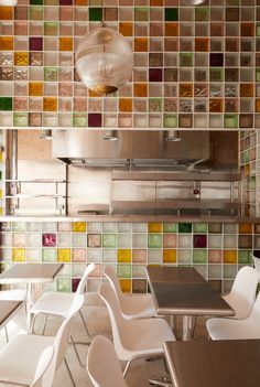 the interior of a restaurant with colorful tiles on the wall