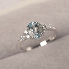 * The delicate ring displays Aquamarine as main stone. The cluster side stones make the ring similar to the blooming flower . For who wearing this special & delicate ring, will shine like a goddess. ◆ Production Description: Main stone Type: Aquamarine Main Stone Shape: Oval Cut Main Stone Size: 6*8mm (1.13ct) Side stone: CZ Metal: 925 Sterling silver - Other options available in the drop down menu ◆ Customization: √Free for Add Engraving √Other Metal Type Available √Other Gemstones & Shapes Ava Silver And Blue Engagement Ring, Blue Engagement Ring Silver, Small Silver Engagement Rings, Blue Promise Rings, Sapphire Engagement Ring Silver, March Birthstone Ring, Silver Wedding Ring, Blue Engagement Ring, Gemstone Ring Silver