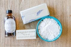 a bottle of soap and some other items on a wooden table with a label for vanilla