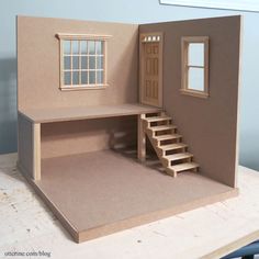 a paper model of a house with stairs and windows