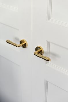 two white doors with brass handles and knobs