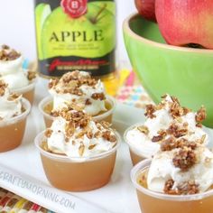 small desserts with whipped cream and apples in the background